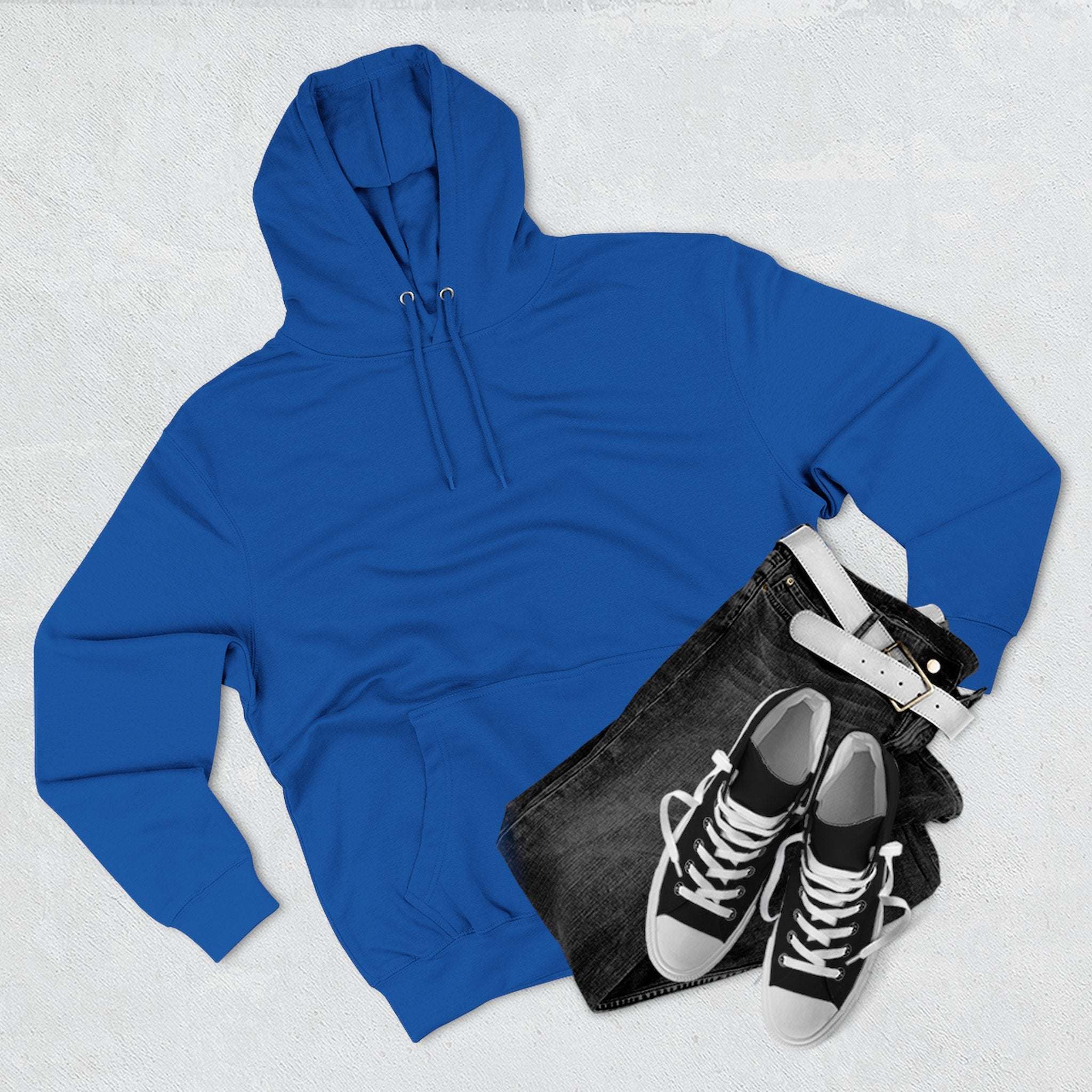 Blue fleece hoodie with adjustable hood, paired with black jeans and black sneakers with white laces