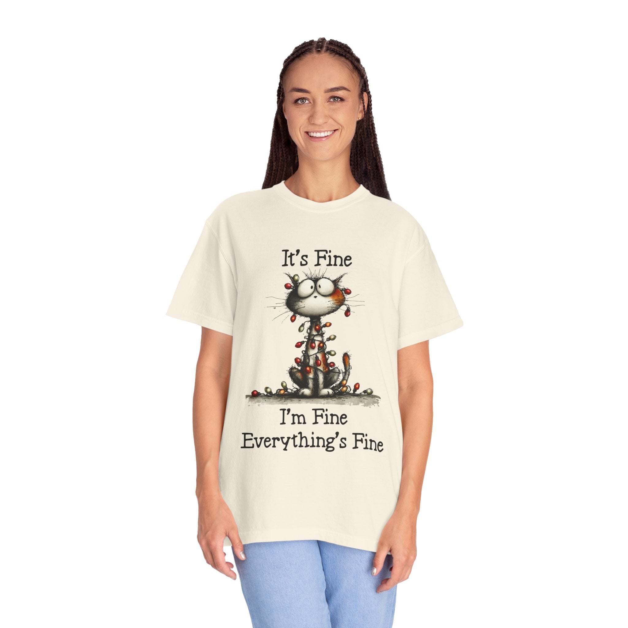 Person wearing a t-shirt with a cat graphic and text on a white background