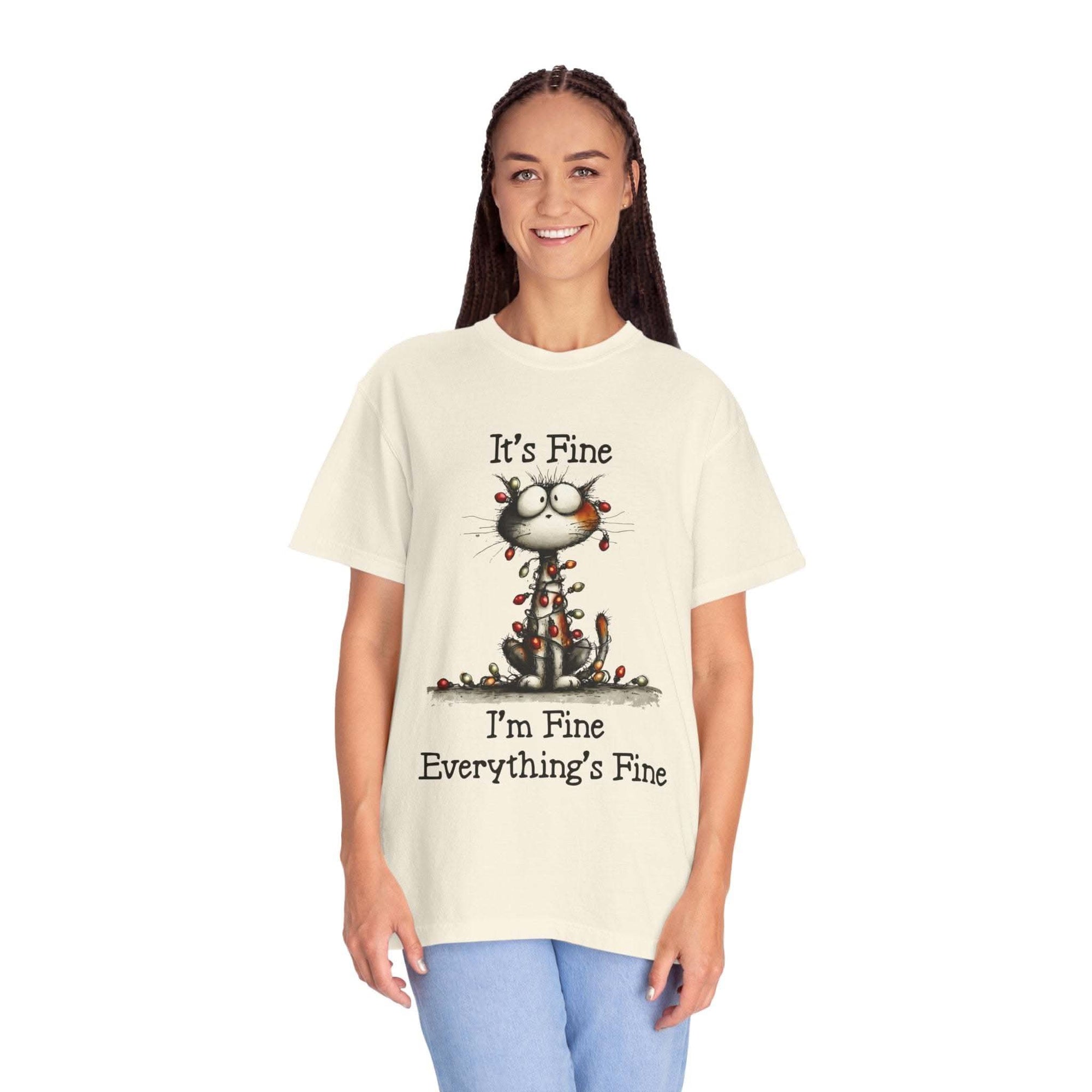 Person wearing a t-shirt with a cat graphic and text on a white background