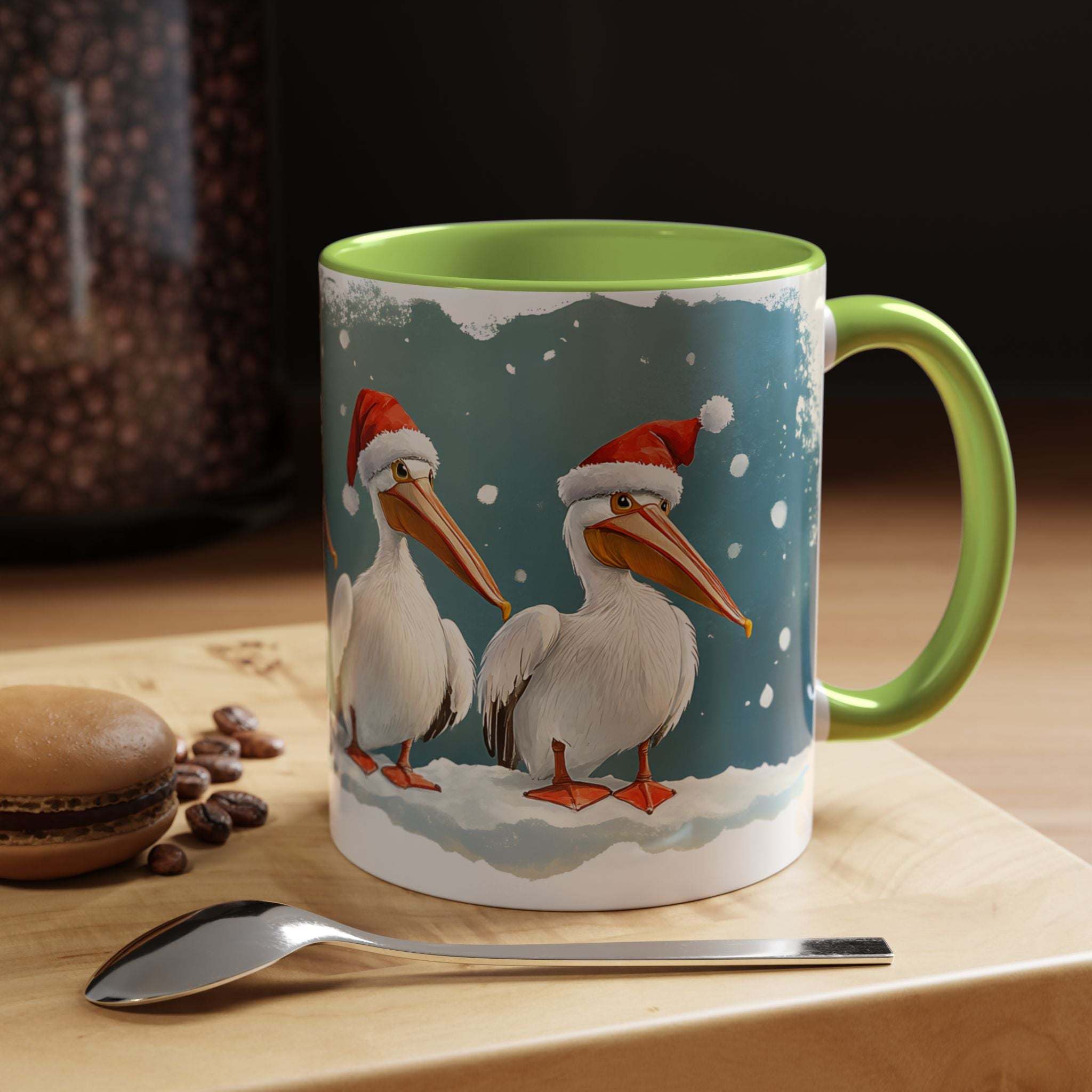 Mug with Christmas-themed design of pelicans wearing Santa hats on a table with coffee beans and a spoon.