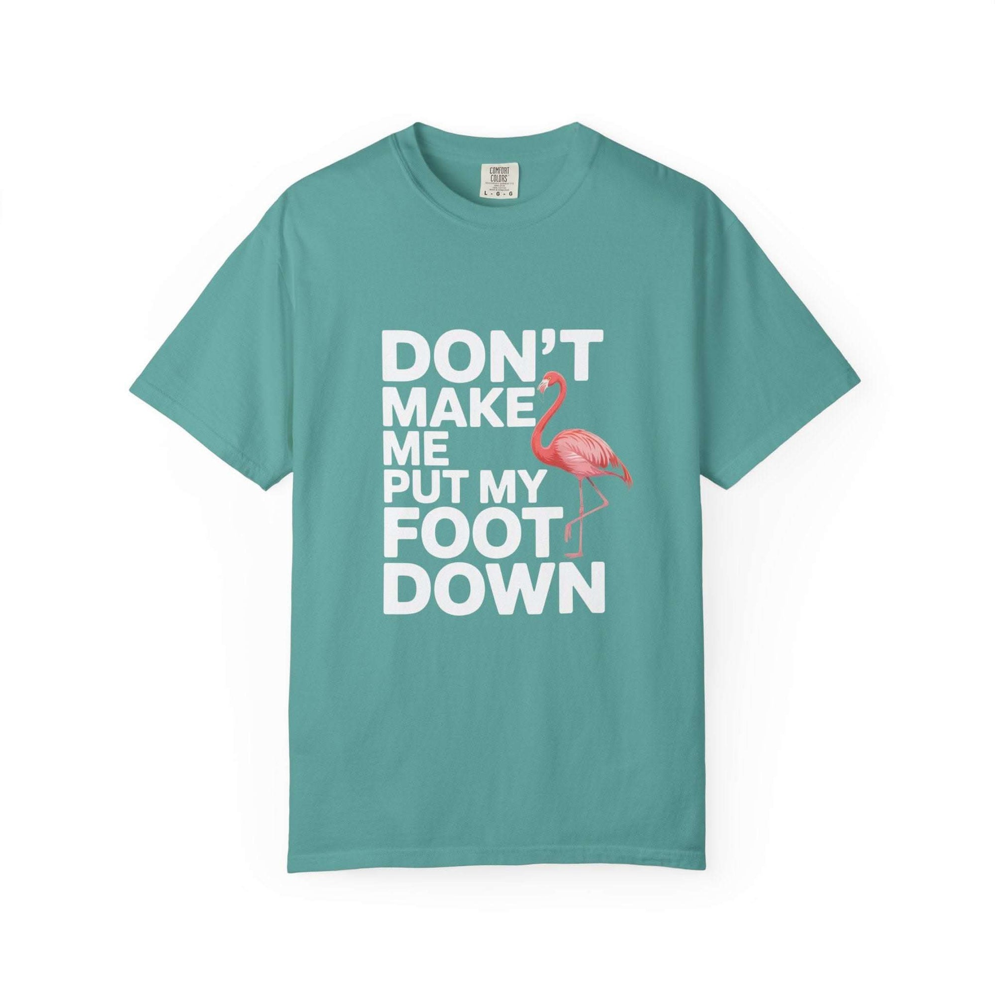 Dont Make Me Put My Foot Down flamingo t-shirt with humorous pink flamingo graphic and bold white text on vintage garment-dyed cotton