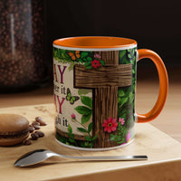 Mug with floral and wooden design on a table with coffee beans and a spoon.