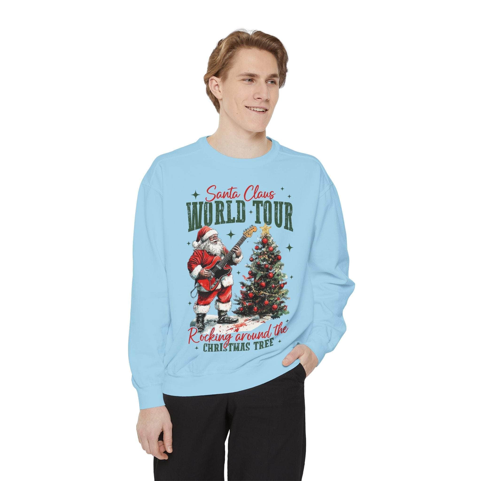 Man wearing light blue Sweatshirt Rocking Santa with festive graphic of Santa playing guitar and Christmas tree