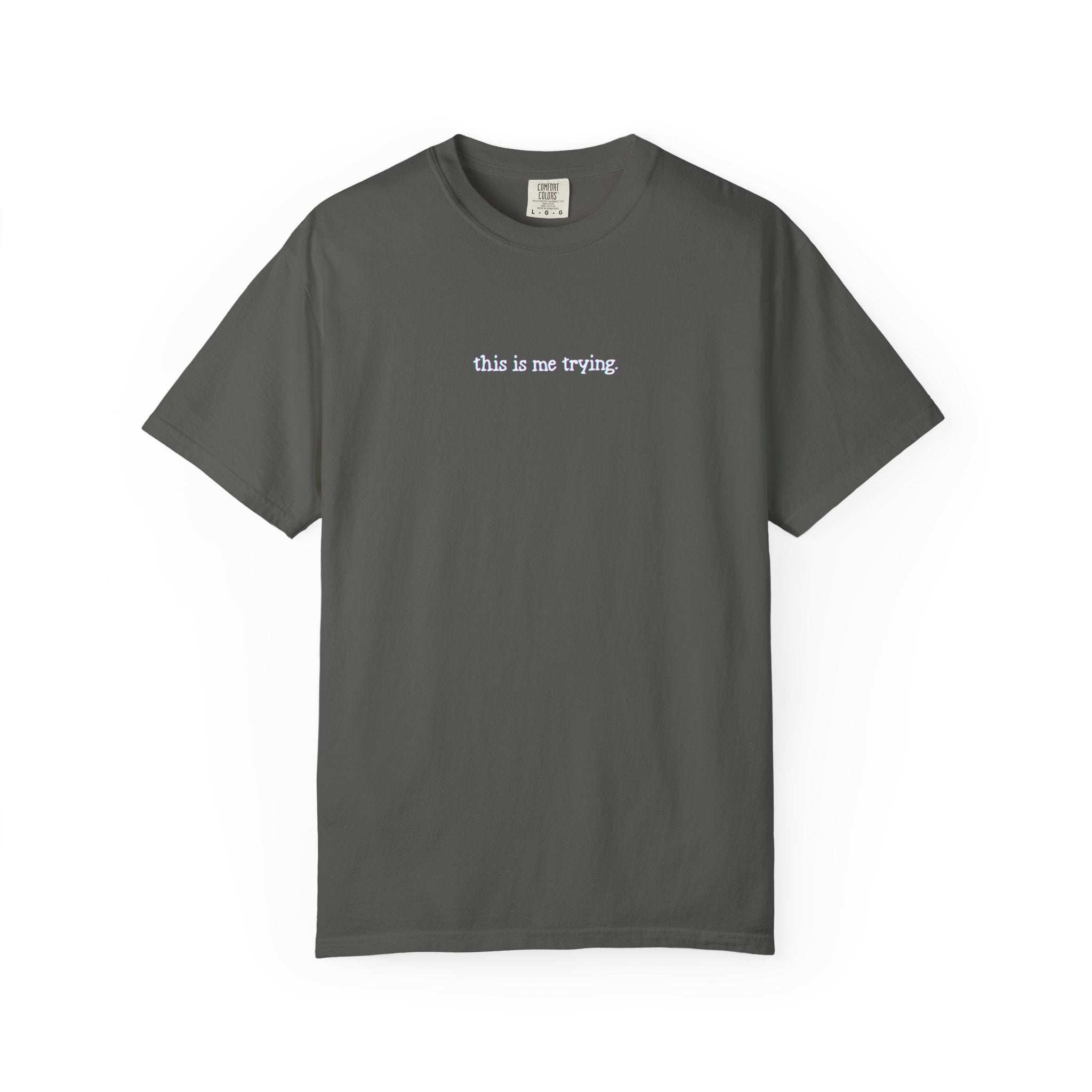 Gray t-shirt with 'this is me trying' text on a white background