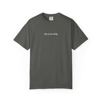 Gray t-shirt with 'this is me trying' text on a white background