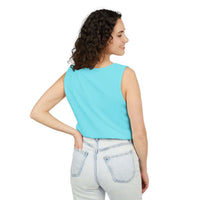 Woman wearing light blue sleeveless tank top paired with light wash jeans viewed from the back
