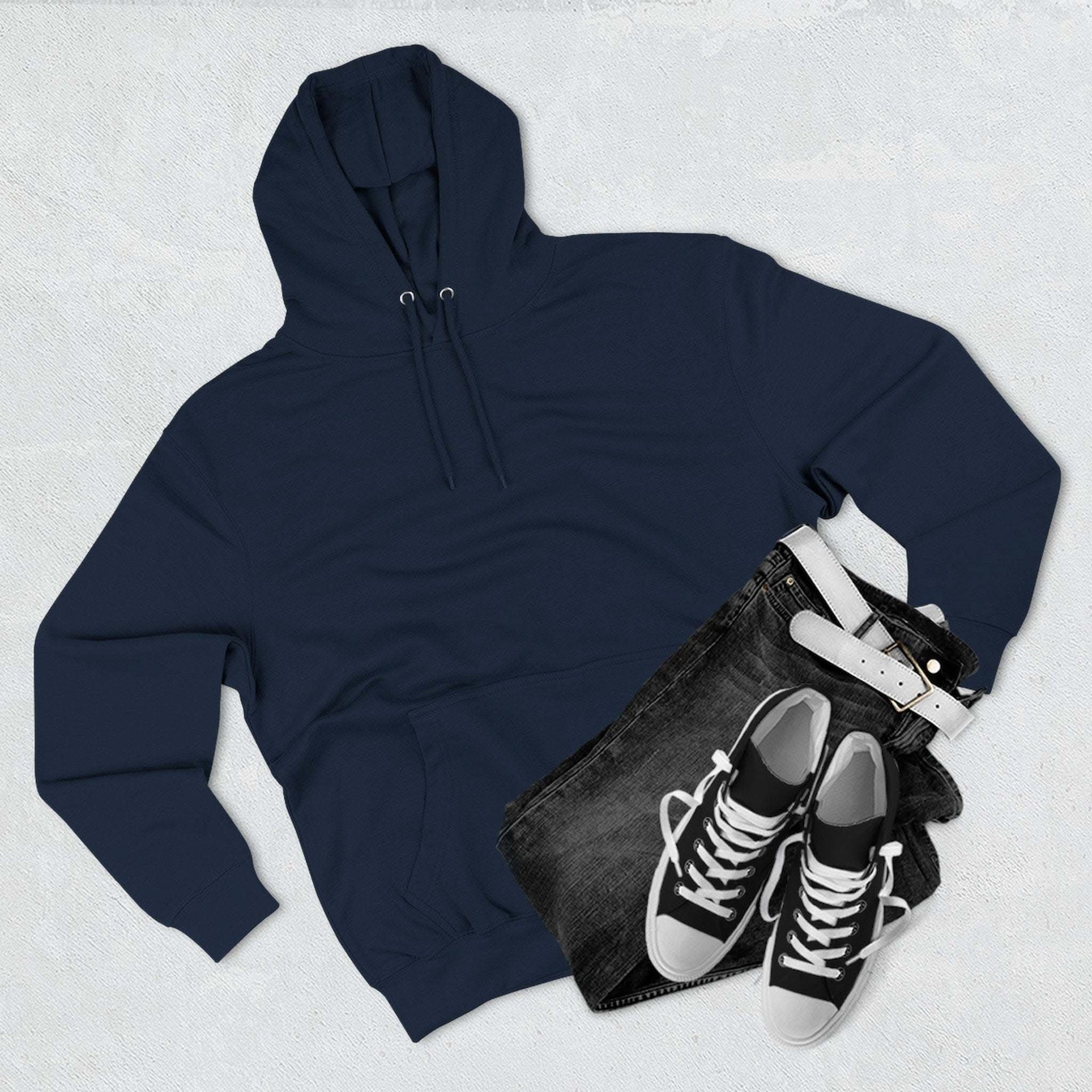 Navy blue fleece hoodie with kangaroo pocket, paired with black jeans and black sneakers, flat lay winter outfit