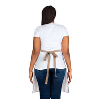 Woman wearing pastel coastal cowgirl apron with beige tie-back straps viewed from behind