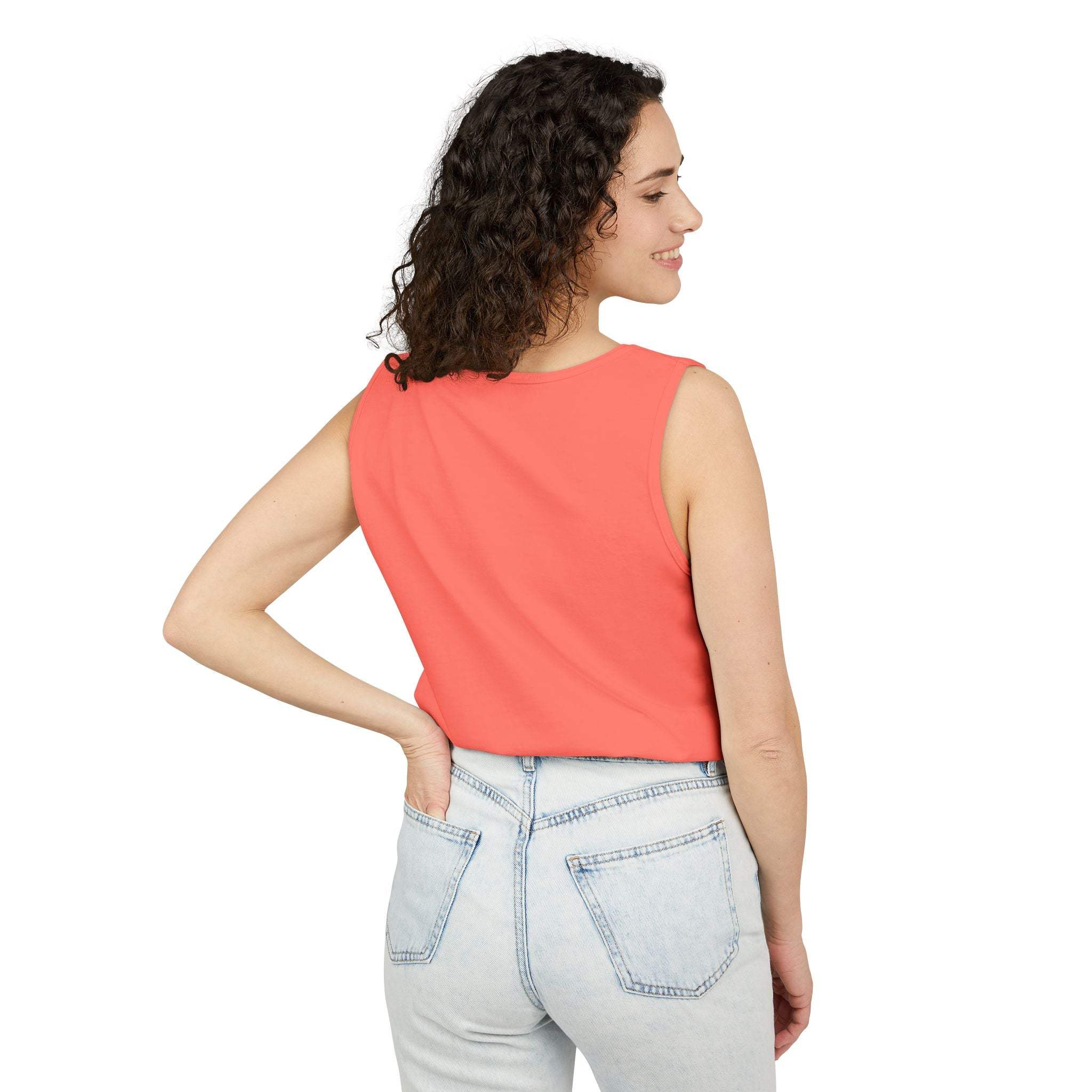 woman wearing coral sleeveless tank top paired with light blue jeans back view