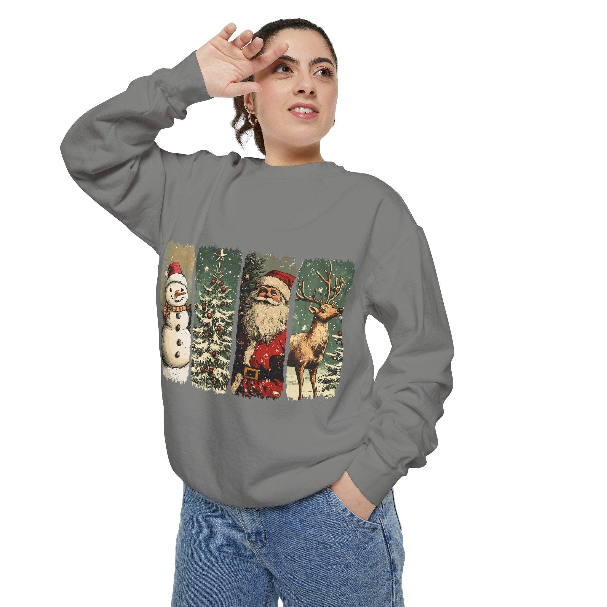 Adult wearing gray vintage Christmas sweatshirt with watercolor swatches of snowman, tree, Santa, and reindeer designs