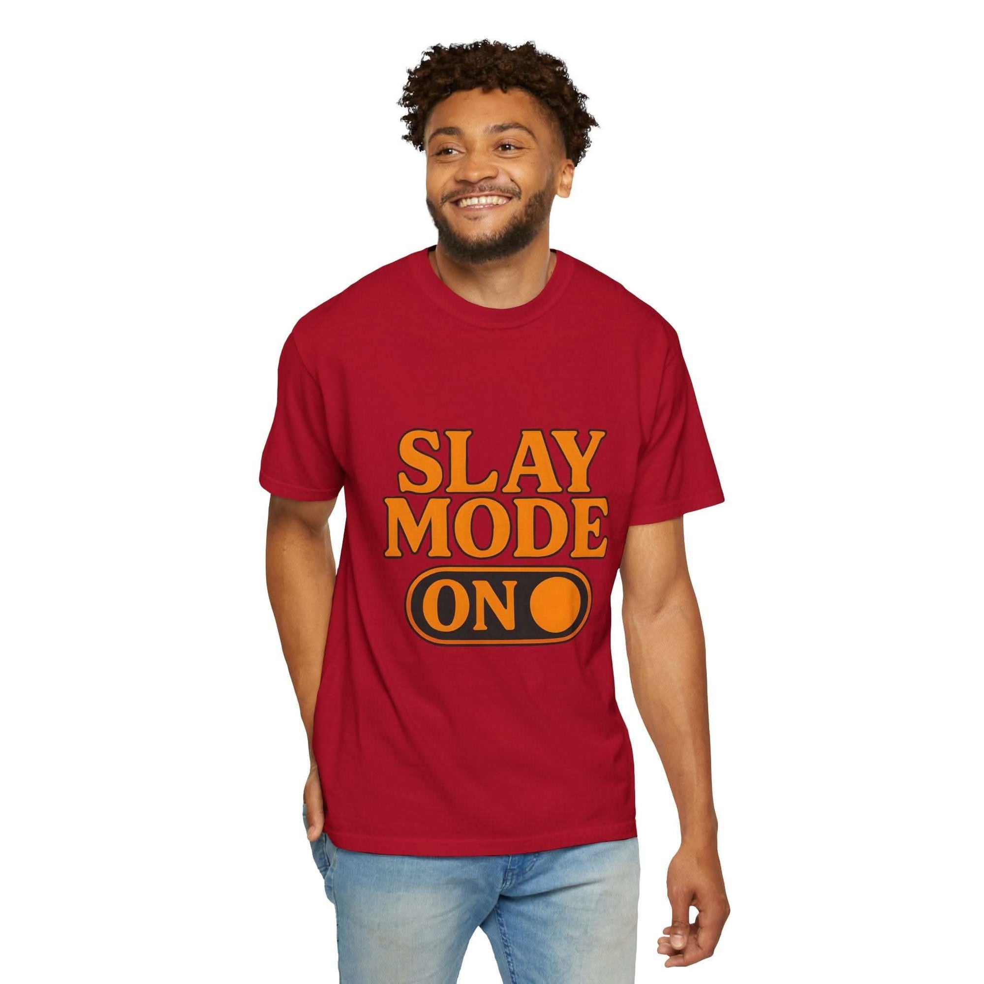 Man wearing red garment-dyed tee with "Slay Mode On" text and blue jeans