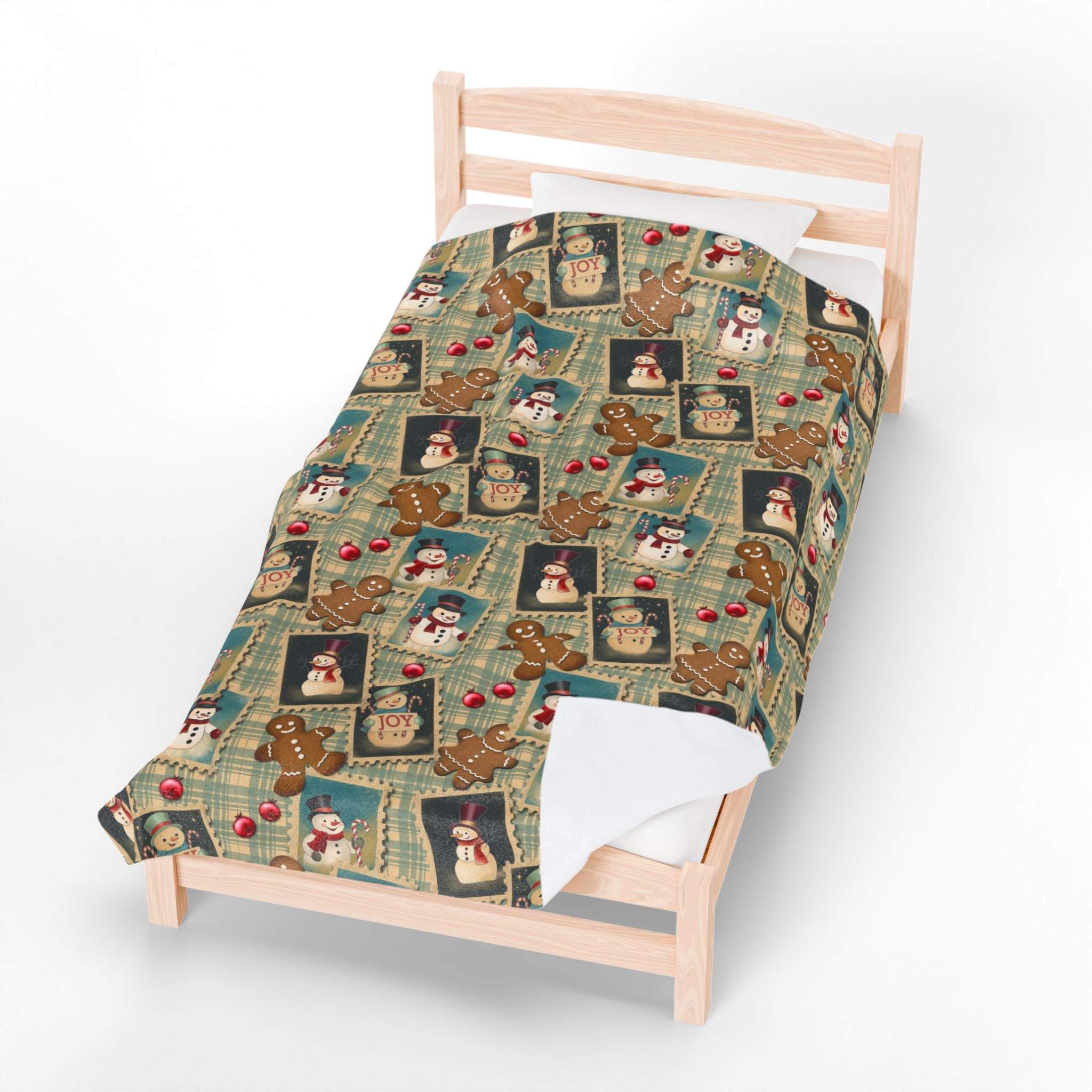 Plush blanket with retro Christmas watercolor design featuring gingerbread men, snowmen, and holiday motifs on a cozy bed cover