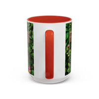 White mug with red interior and handle, featuring a floral pattern on the sides.