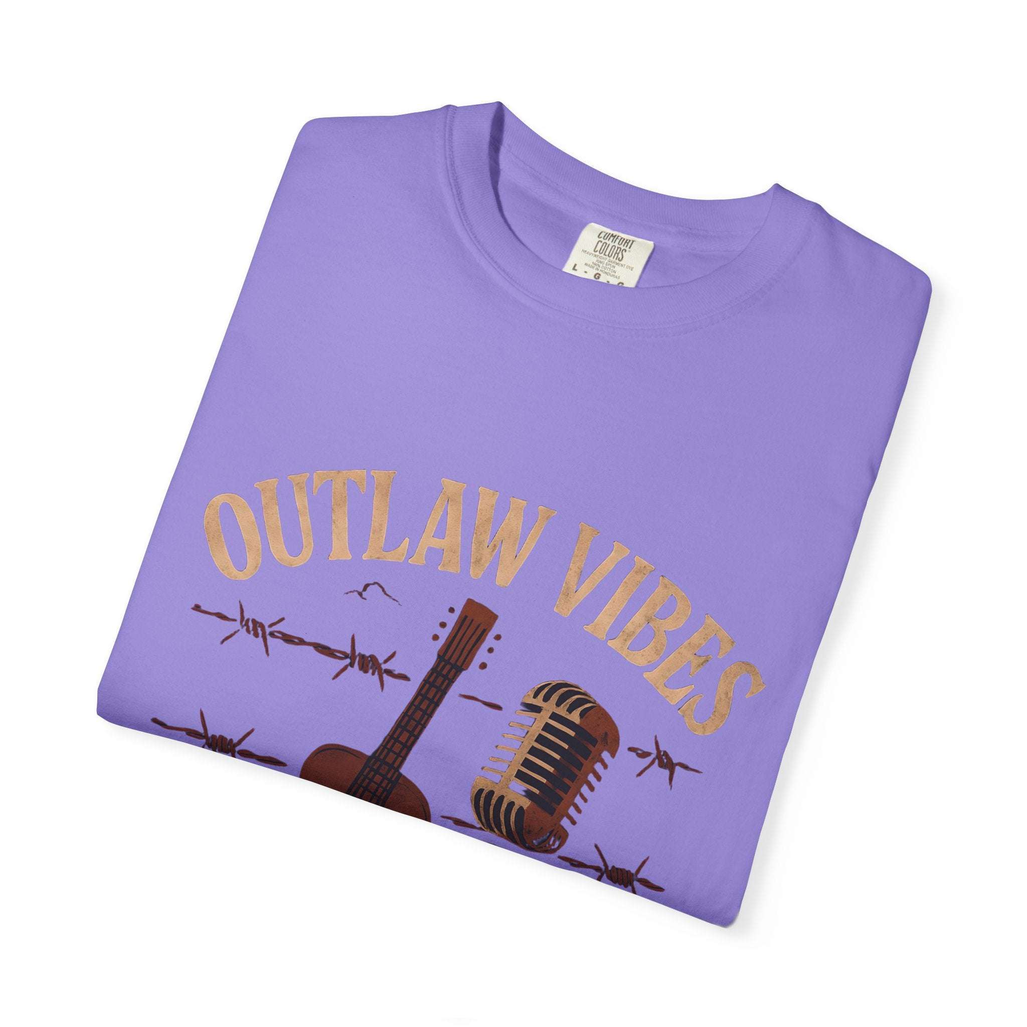 Folded purple t-shirt with 'Outlaw Vibes' text and guitar graphic on a white background