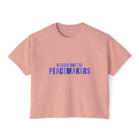 Women's boxy pink tee with "Blessed be the Peacemakers" text in blue, vintage style