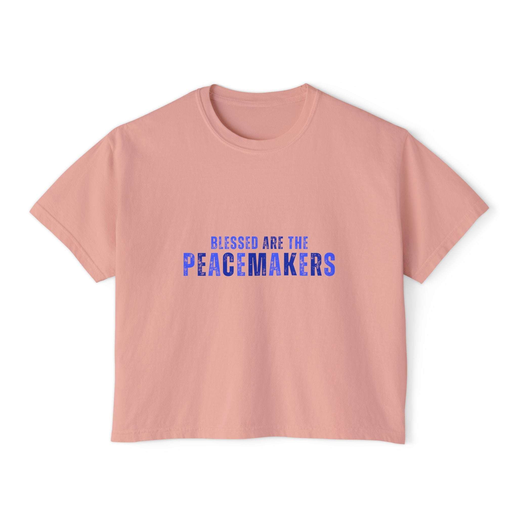 Women's boxy pink tee with "Blessed be the Peacemakers" text in blue, vintage style