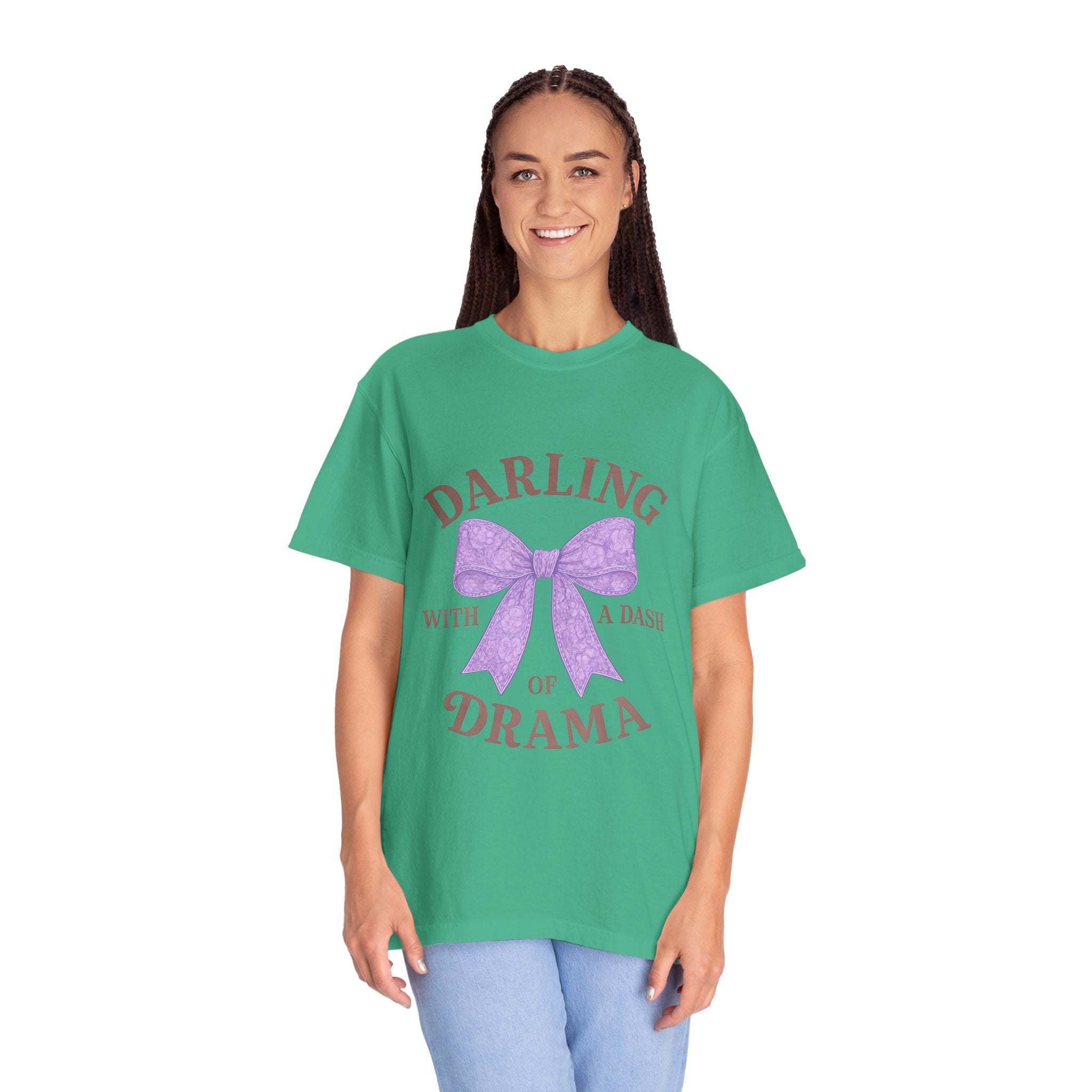 Person wearing a green t-shirt with a purple bow and text on a white background