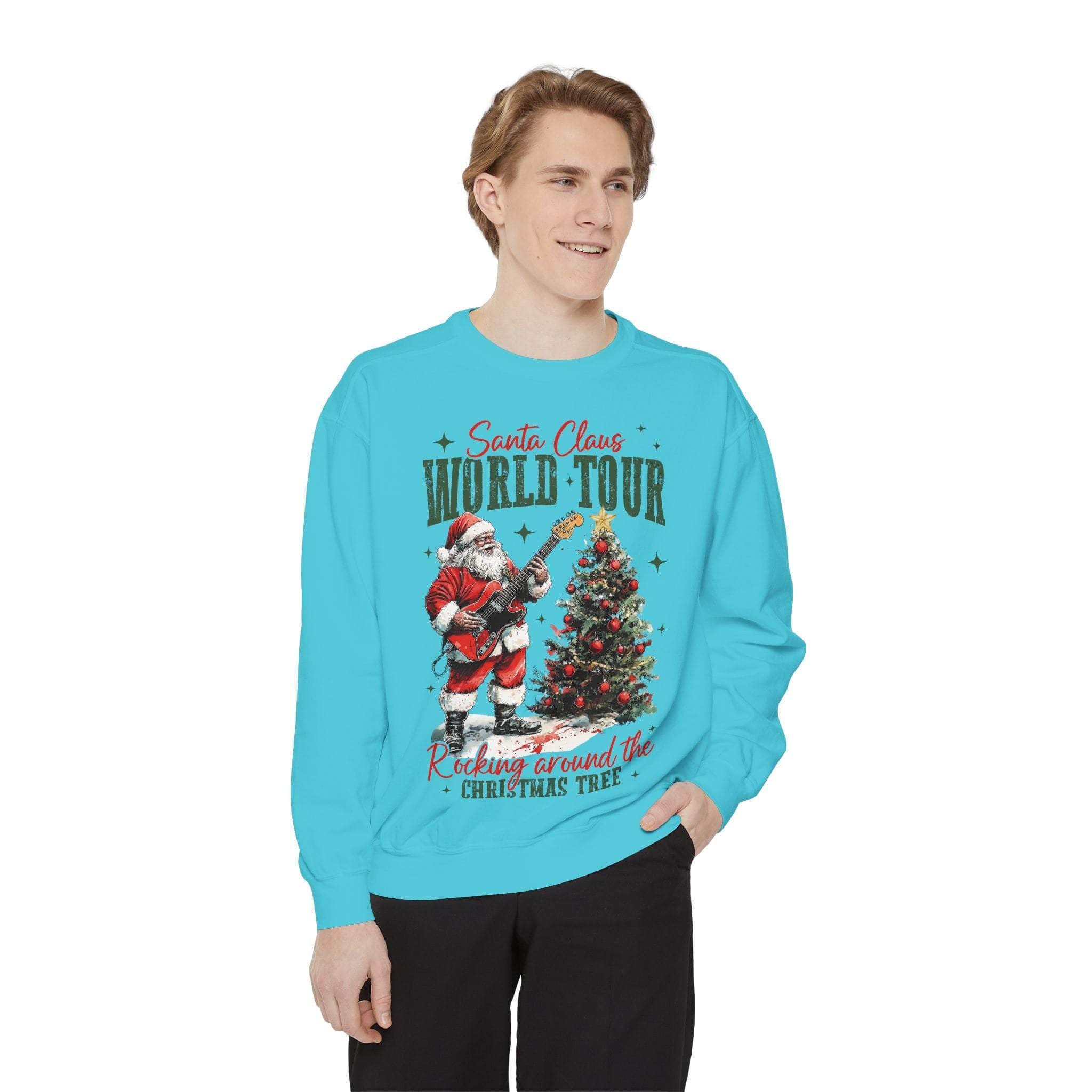 Man wearing a festive blue Sweatshirt Rocking Santa with a Santa Claus playing guitar and Christmas tree design.