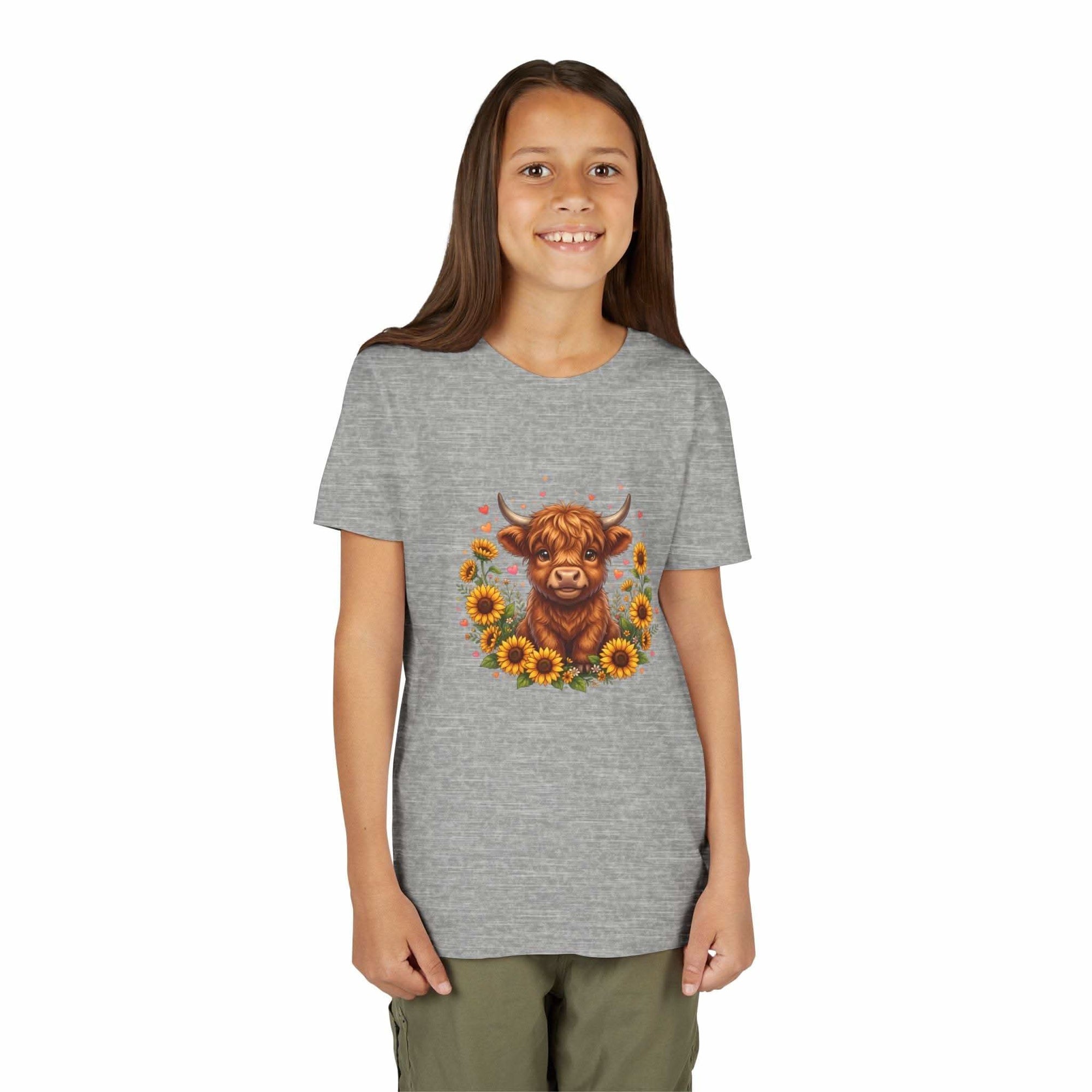 Youth tee featuring a Highland cow surrounded by bright sunflowers with a countryside theme.