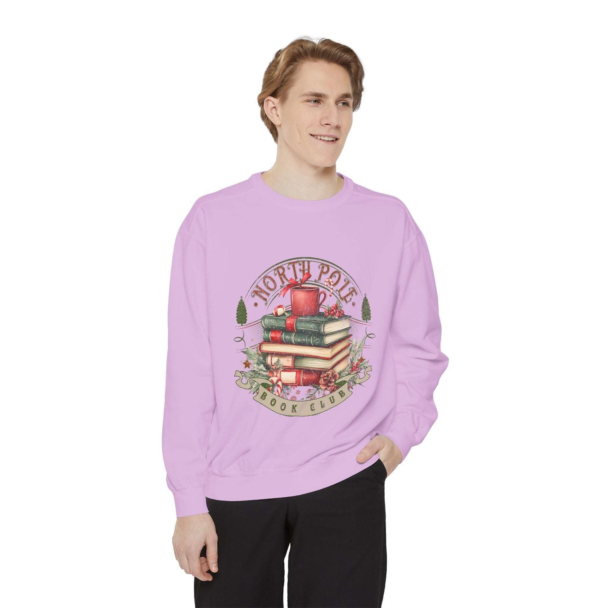 Man wearing a vintage North Pole Book Club lavender sweatshirt with cozy holiday design and book stack graphic