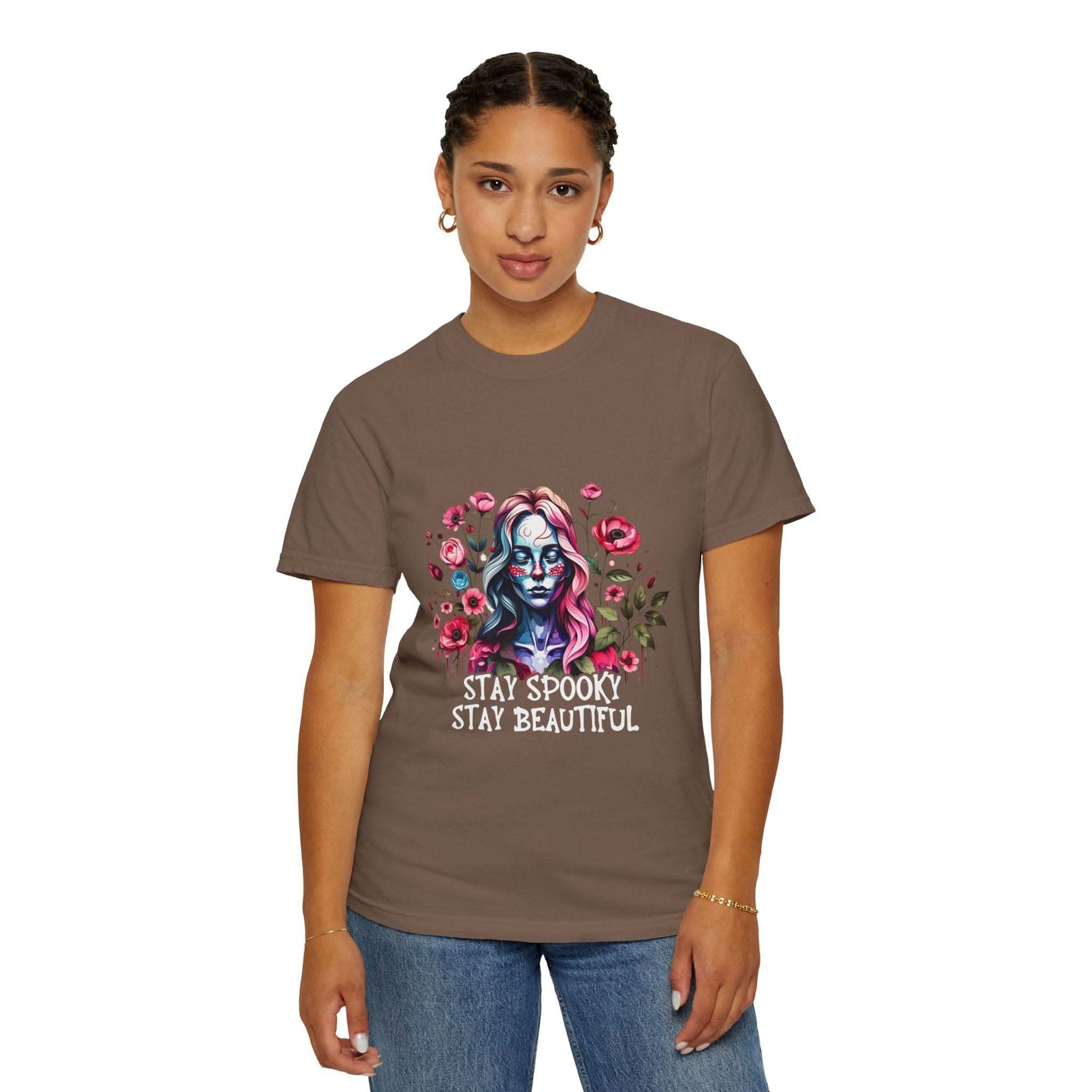 Woman wearing soft everyday tee with elegant floral skeleton print and "Stay Spooky Stay Beautiful" text, relaxed fit floral skeleton t-shirt
