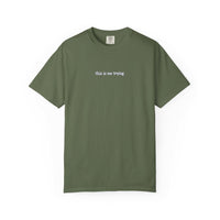Green t-shirt with 'this is me trying' text on a white background