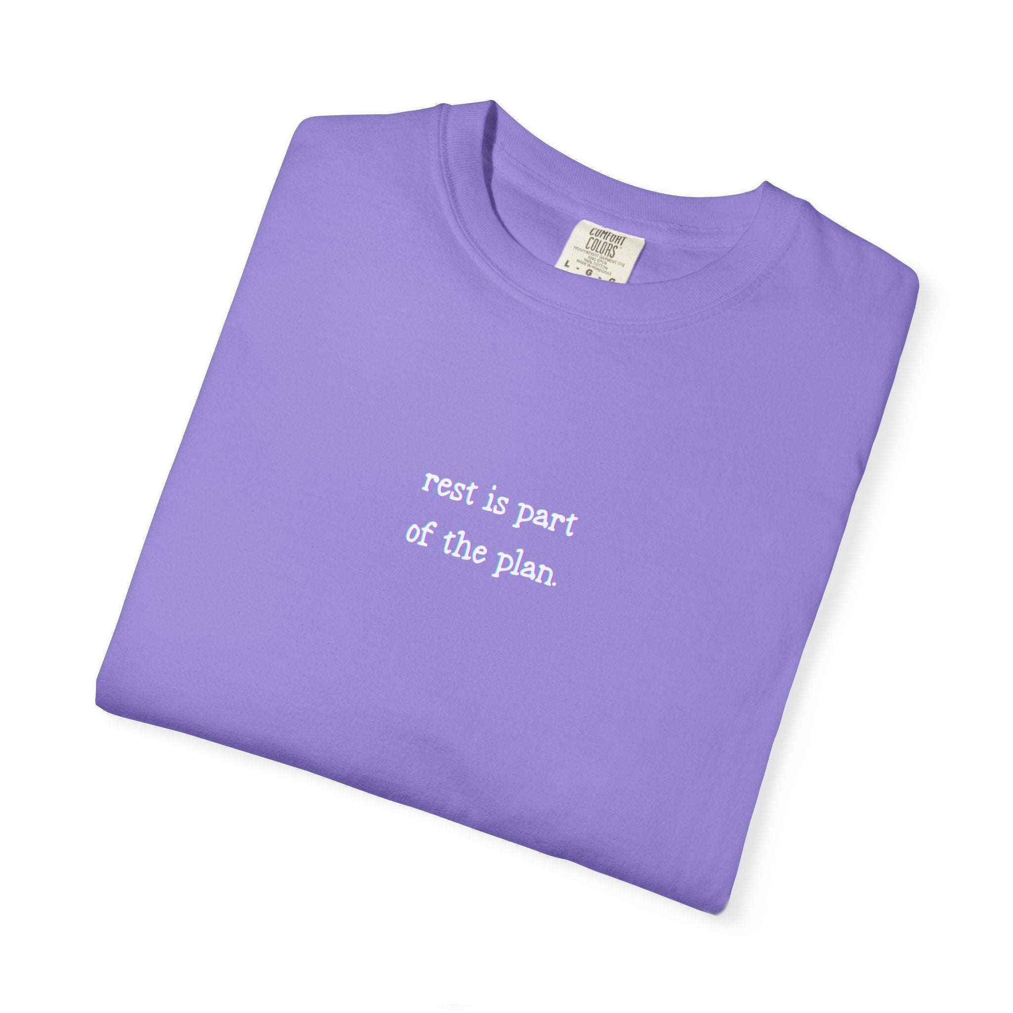 Folded purple t-shirt with text on a white background