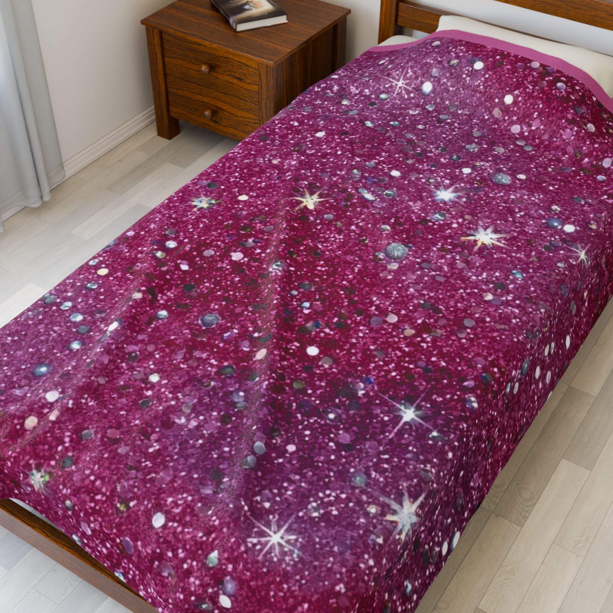 Starry pink plush blanket on bed with cozy velveteen fabric and sparkly design