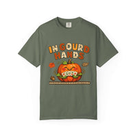 An olive green short-sleeve t-shirt with a festive Halloween graphic on the front. The graphic features the text 'IN GOURD HANDS' in orange and yellow, above a smiling orange pumpkin with a 'OH EWA' sign for its eyes, set against a clean white background.