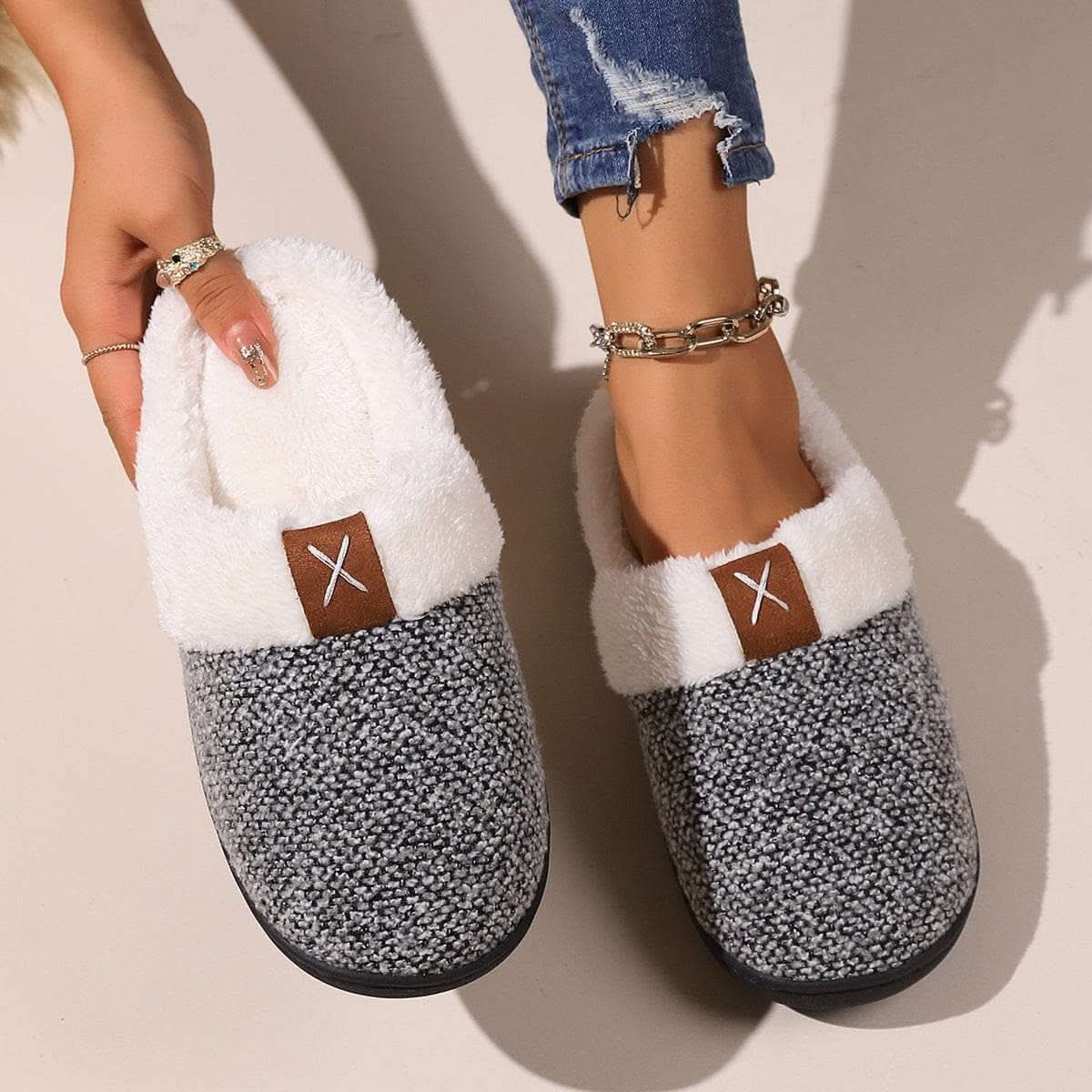 Pair of burgundy winter plush slippers with round toe and cartoon pattern for indoor warmth and comfort