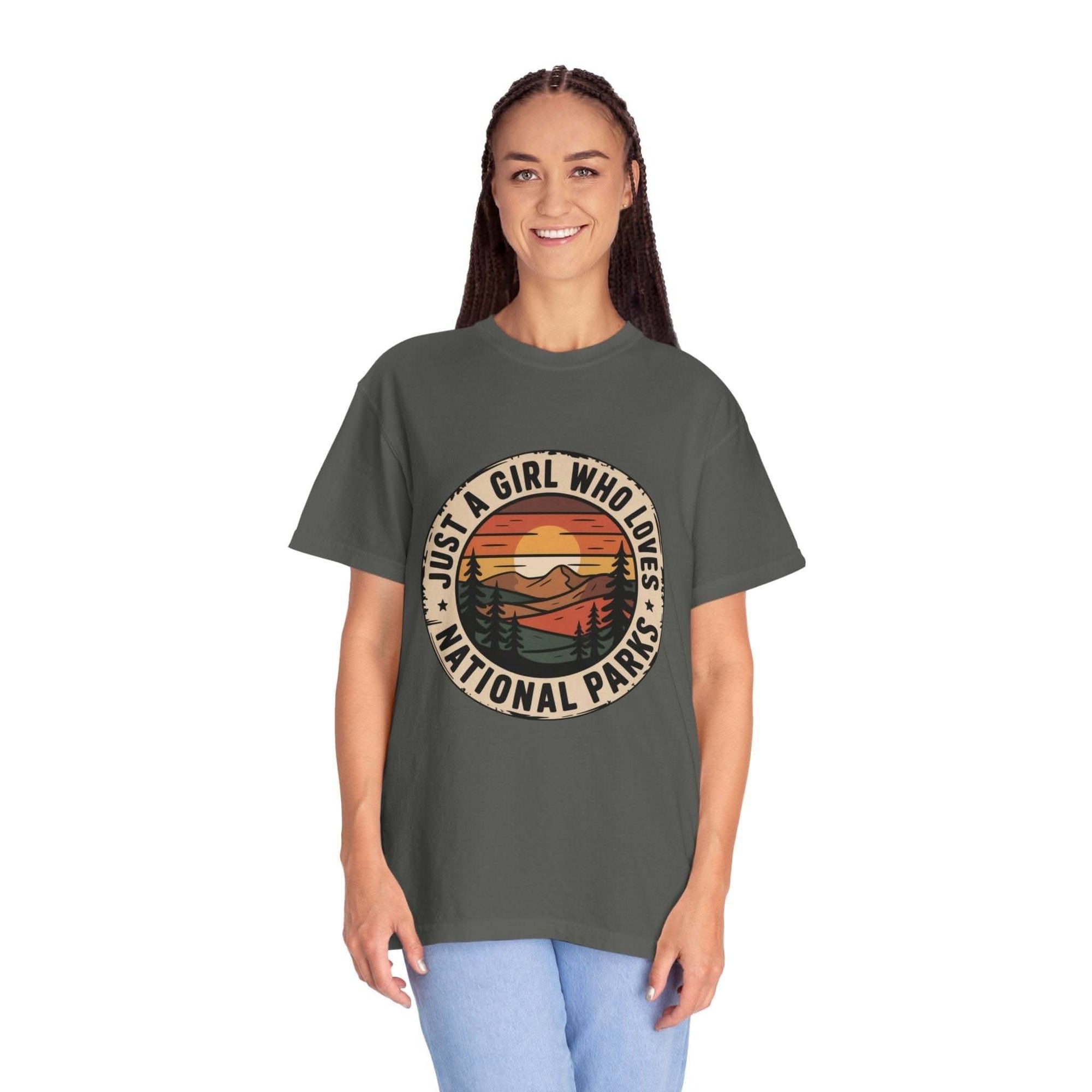 woman wearing olive green National Parks T-Shirt with sunset and mountain graphic