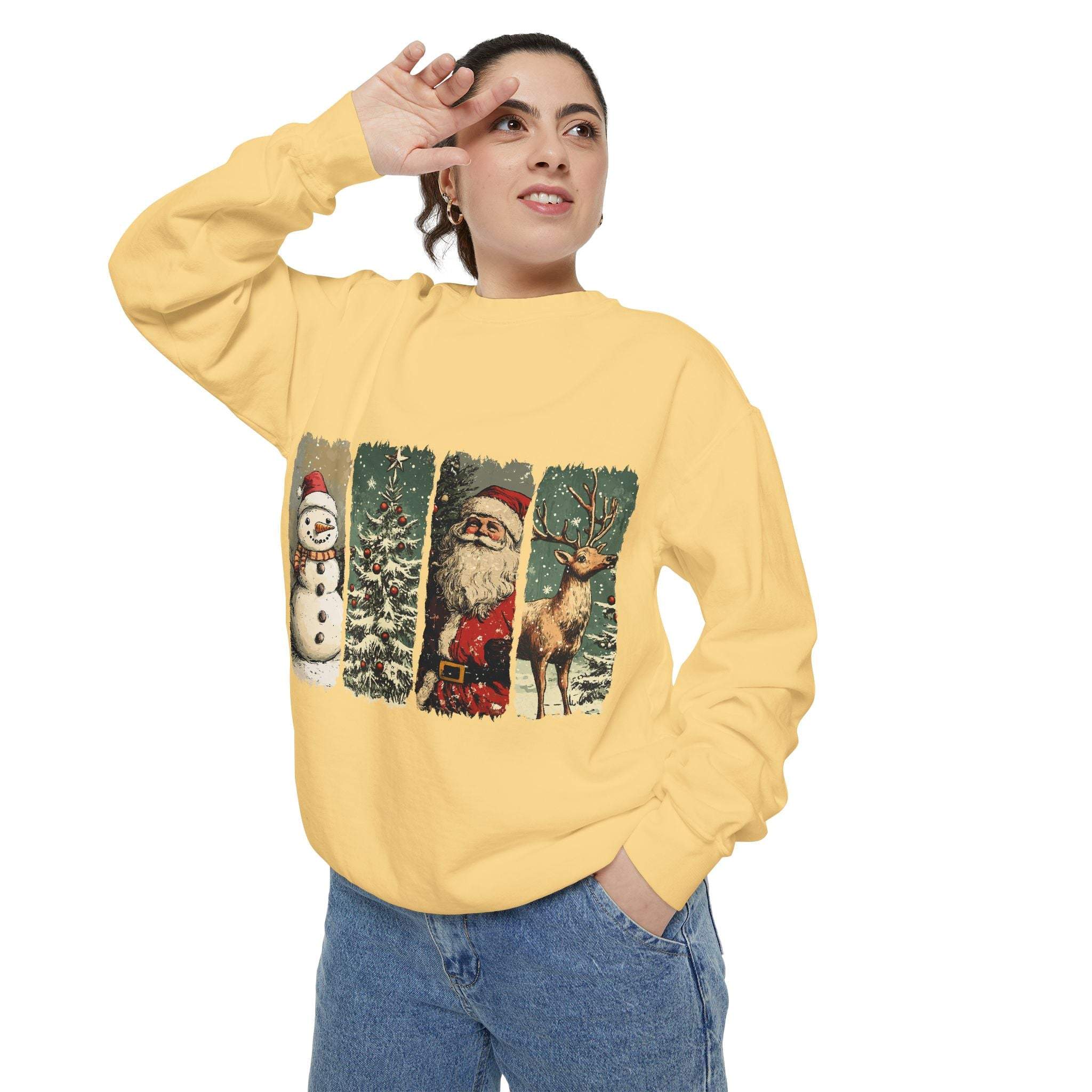 Woman wearing a yellow vintage Christmas sweatshirt with watercolor swatches of snowman, Santa, tree, and reindeer designs