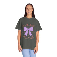Woman wearing a dark gray t-shirt with a purple bow and text on a white background