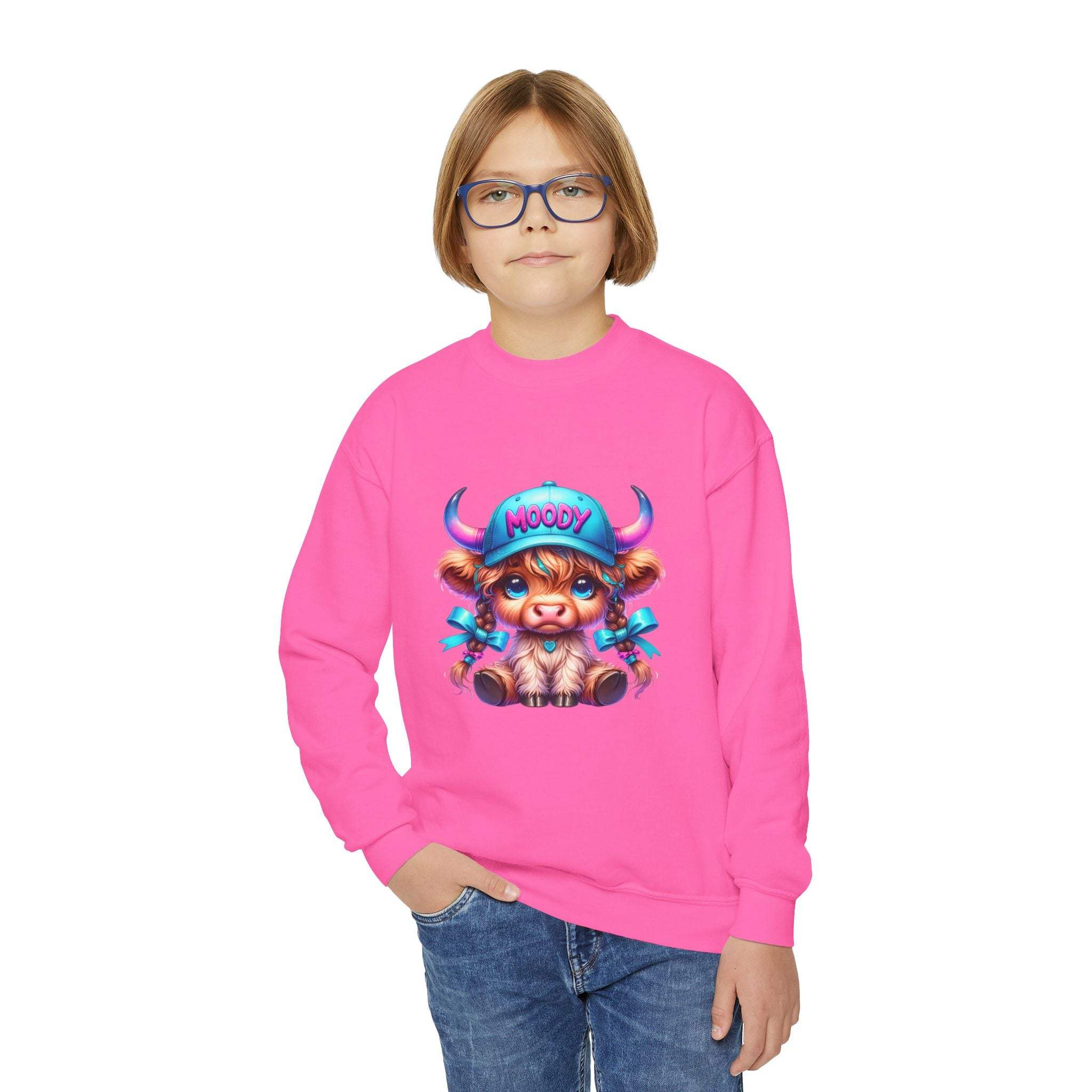 Child wearing bright pink Moody Girl Highland Cow sweatshirt with cartoon cow graphic and blue glasses