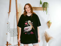 Valentine Pelican Hearts T-Shirt with pelican carrying heart on sunlit shoreline, soft garment-dyed cotton, relaxed fit, vintage coastal style