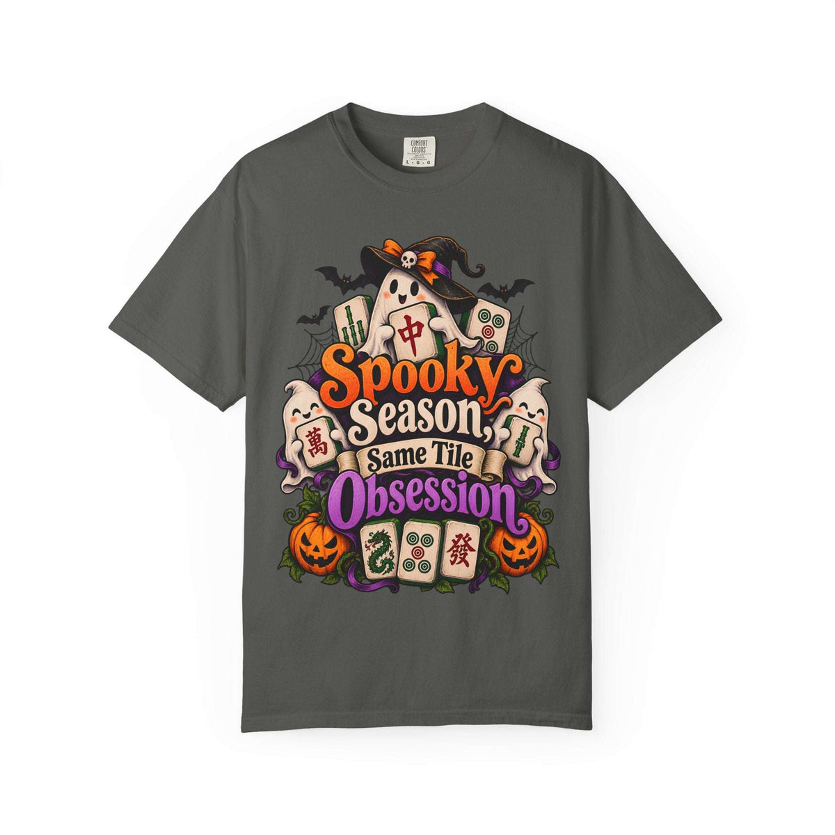 Flat lay of a pepper grey Halloween mahjong T-shirt with ghosts, pumpkins, mahjong tiles and “Spooky Season, Same Tile Obsession” lettering.