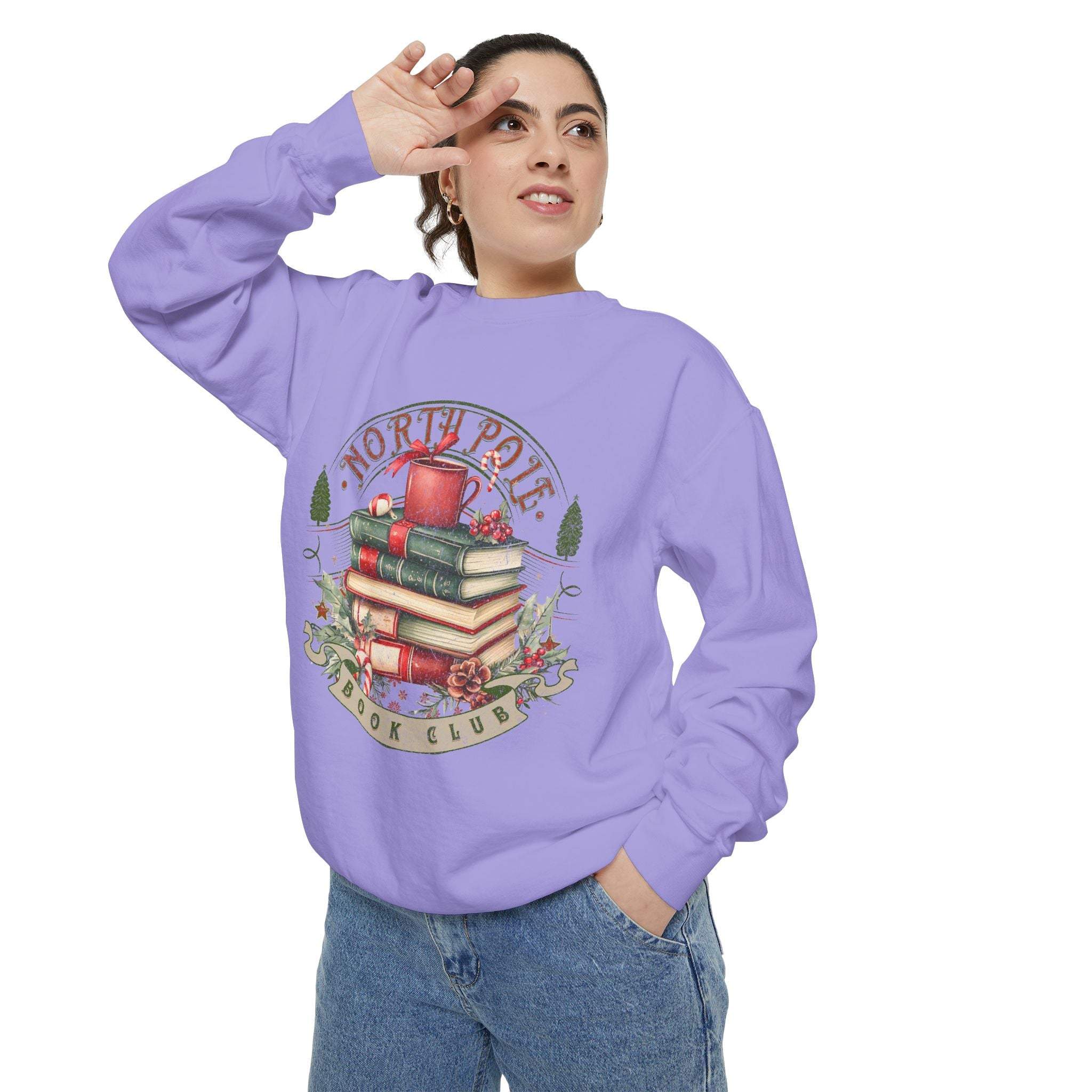 Woman wearing lavender Vintage North Pole Book Club sweatshirt with book and holiday design
