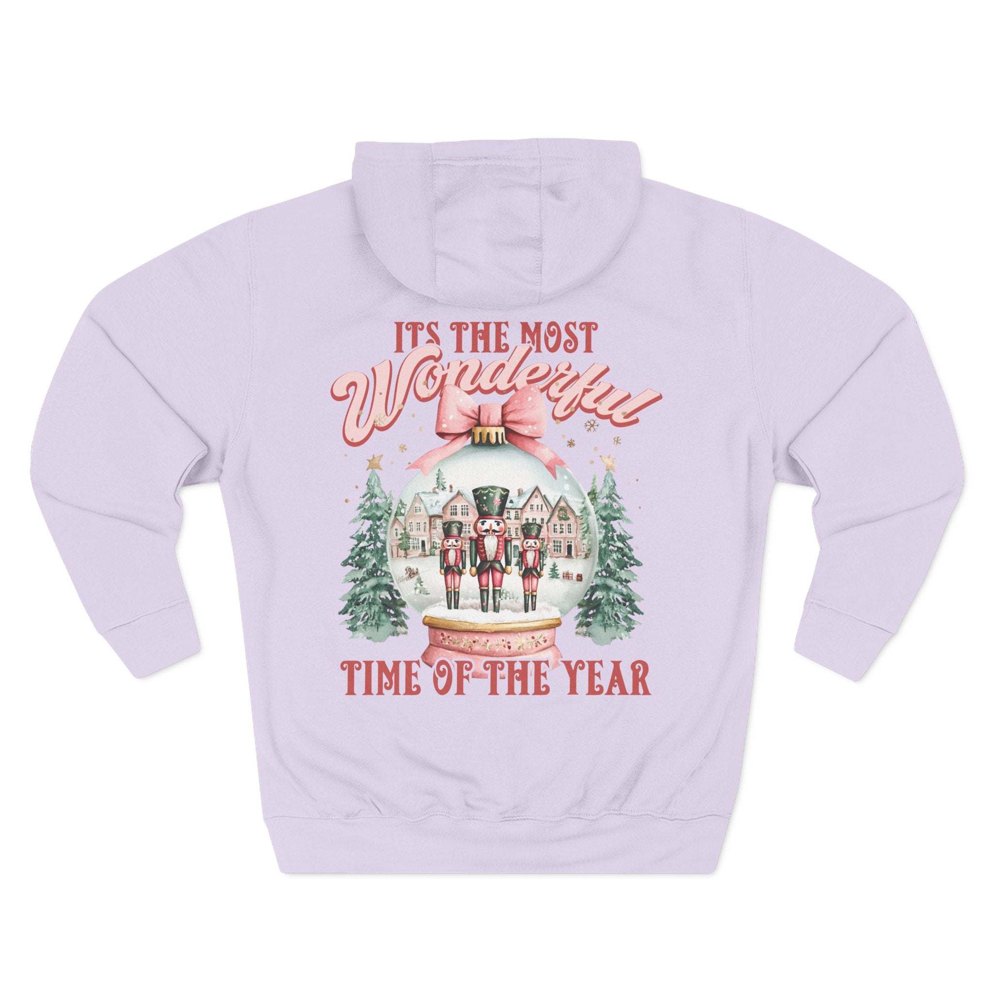 Preppy pink fleece hoodie with snow globe and nutcracker design for holiday comfort