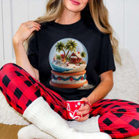 Tropical Snow Globe T-shirt with palm tree snow globe design on soft cotton, festive warm-weather Christmas tee