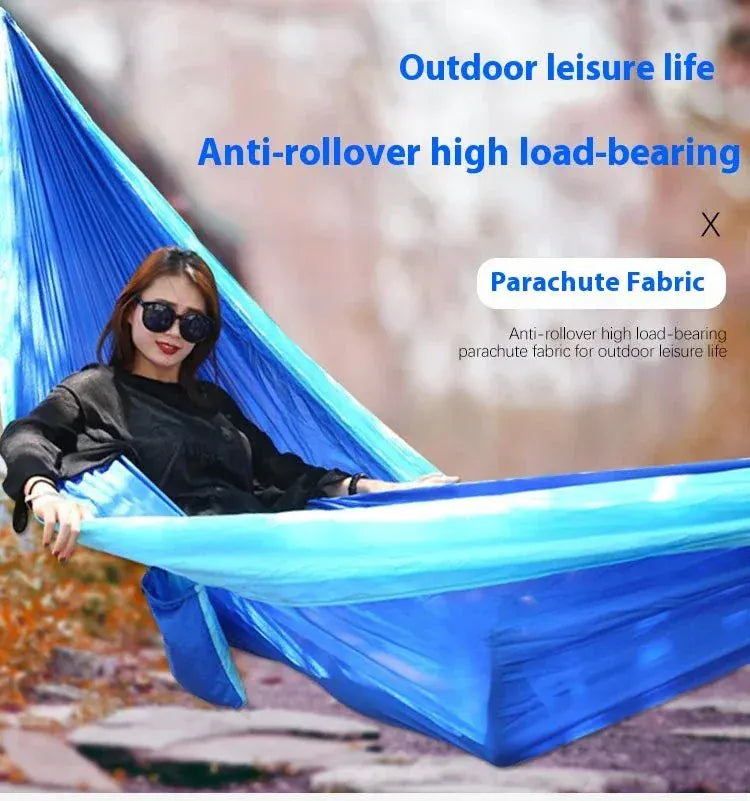 Blue nylon portable outdoor hammock made of high-strength parachute fabric, ideal for camping and leisure.