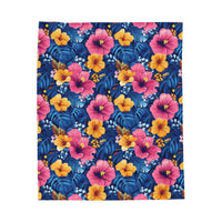 Tropical hibiscus floral velveteen plush blanket with bright pink and gold Hawaiian flower pattern on midnight blue background