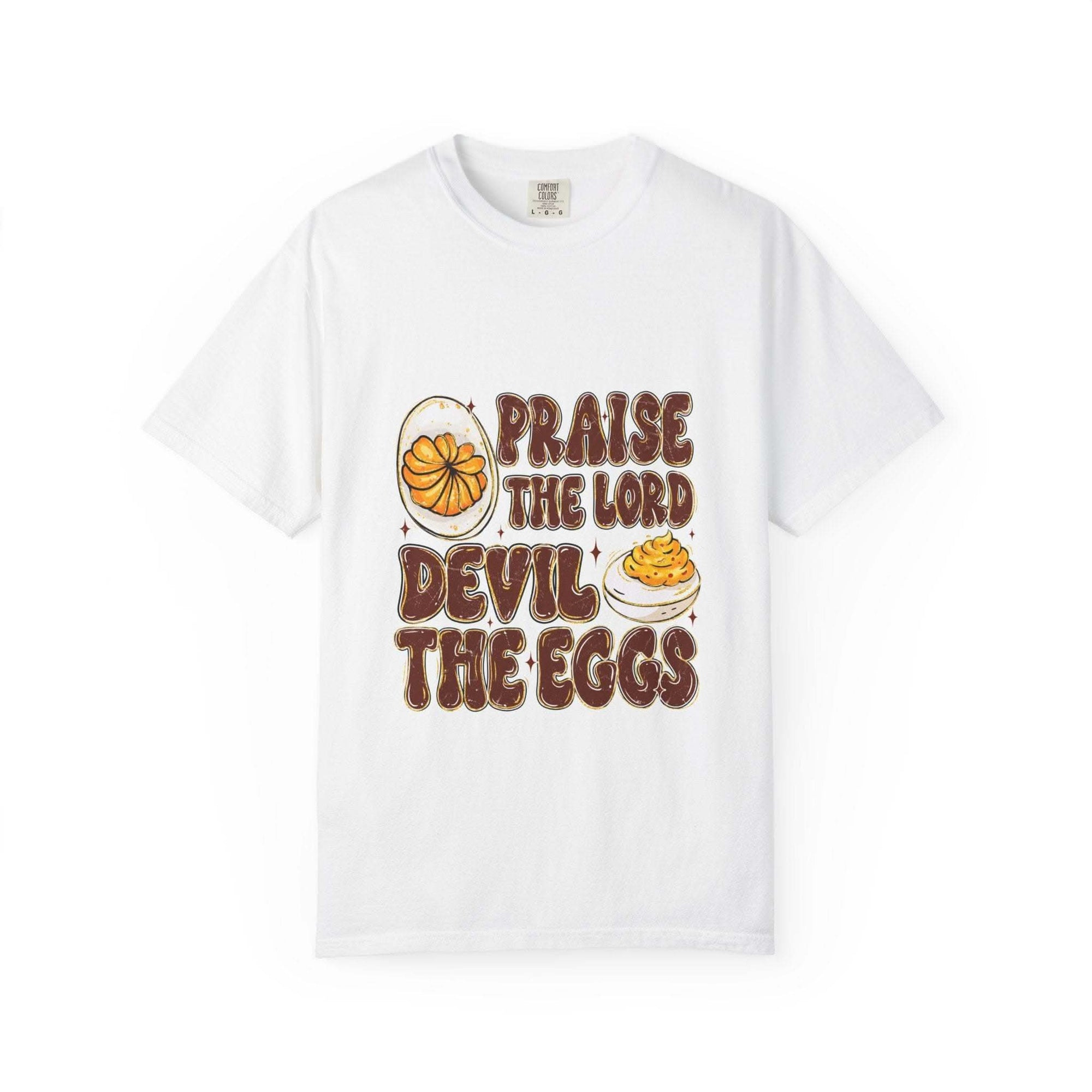 White cotton t-shirt featuring 'Praise the Lord, Devil the Eggs' design, perfect for Easter and Christian apparel.