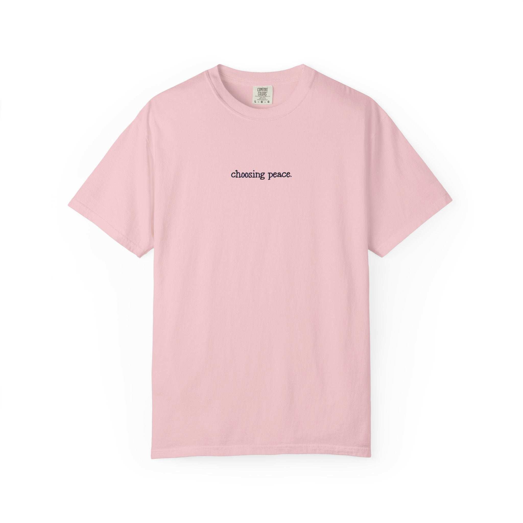 Pink t-shirt with 'chasing peace' text on a white background
