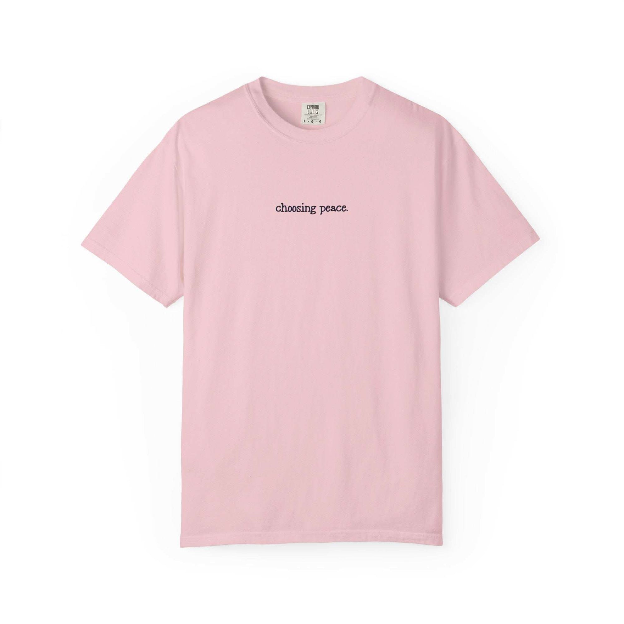 Pink t-shirt with 'chasing peace' text on a white background