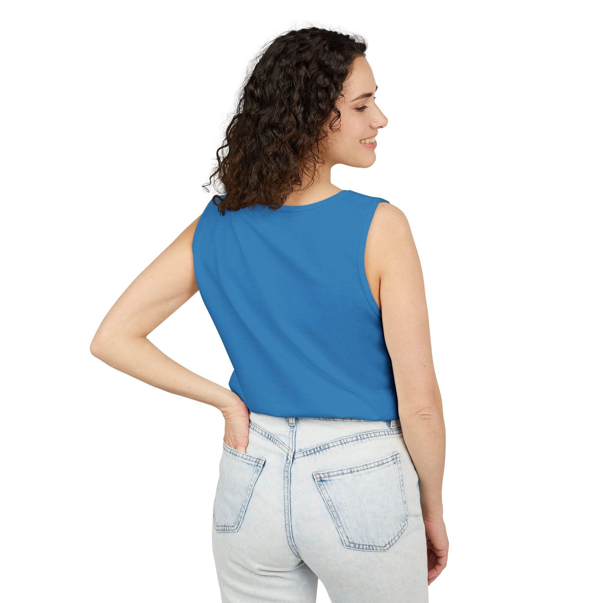 Woman wearing blue tank top, back view, paired with light denim jeans, casual summer outfit