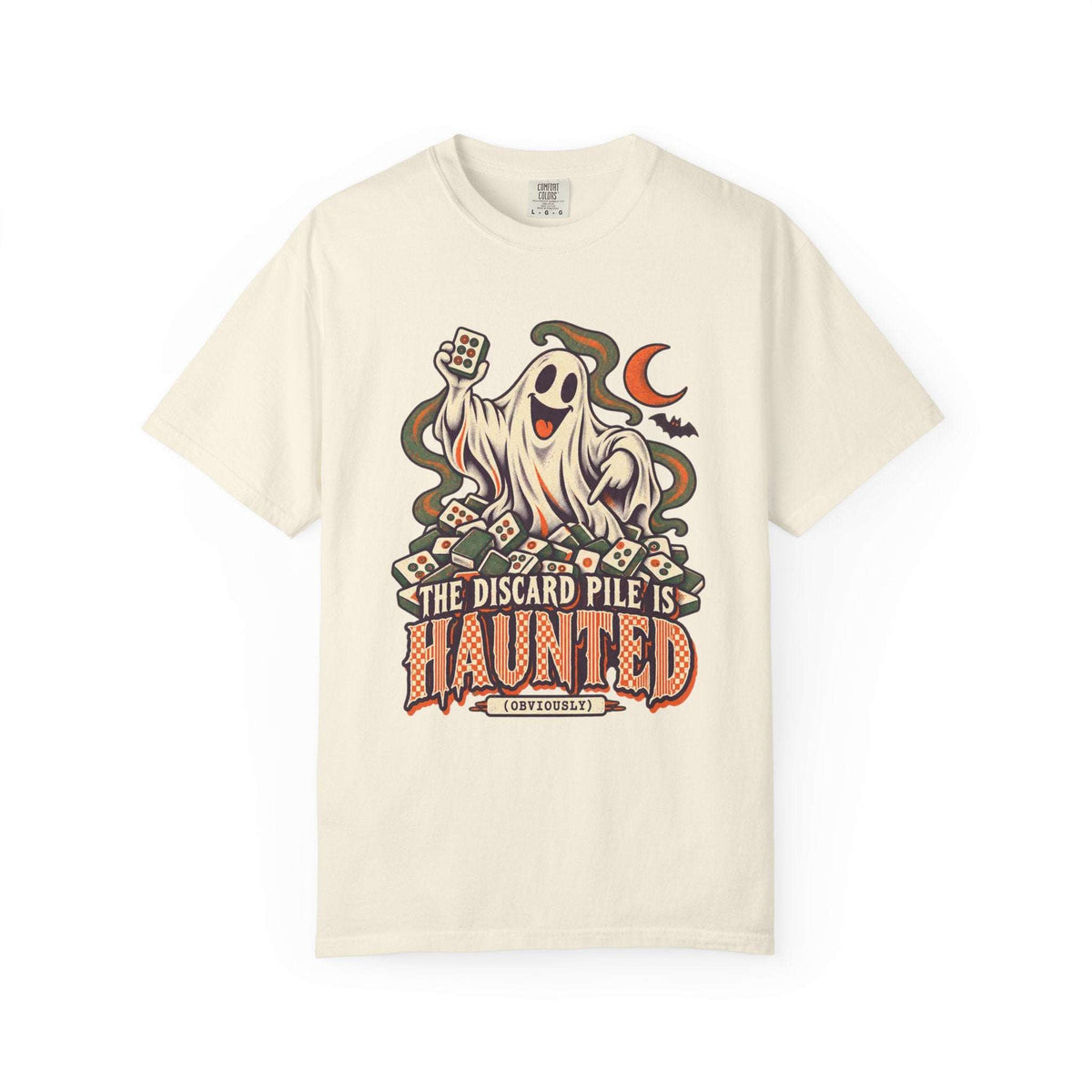 Ivory Comfort Colors 1717 Halloween mahjong T-shirt with a ghost holding a tile and “The Discard Pile Is Haunted (Obviously)” lettering.