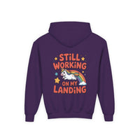 Kids hoodie with colorful unicorn and rainbow design, "Still Working On My Landing" text, cozy kangaroo pocket, durable fabric for active kids