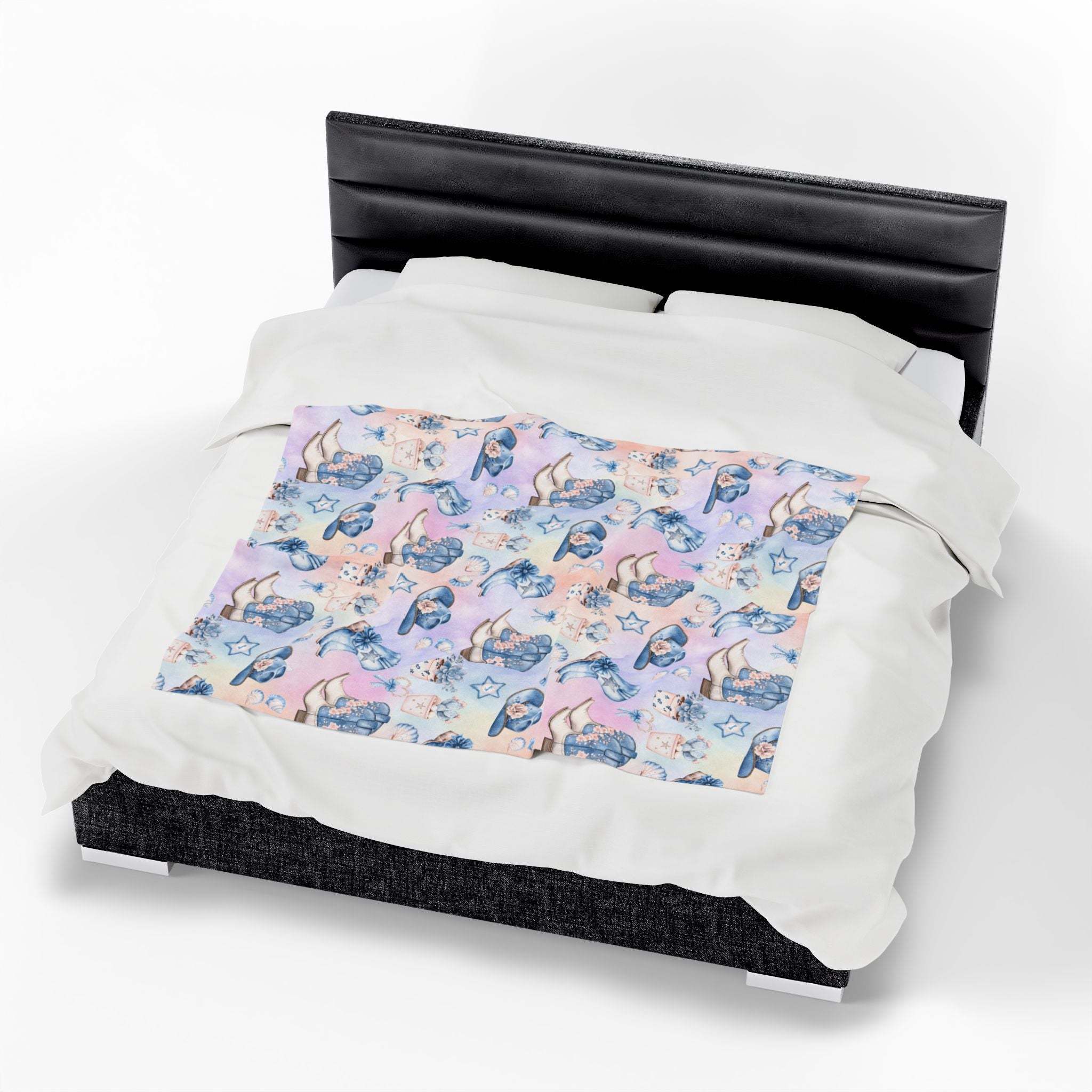 Coastal Cowgirl design plush blanket on bed with pastel beach and horse pattern