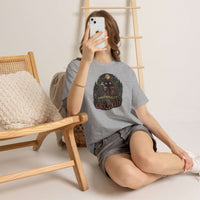 Surreal glowing-eyed mothman cryptid wrapped in blanket holding coffee mug on cryptid tee