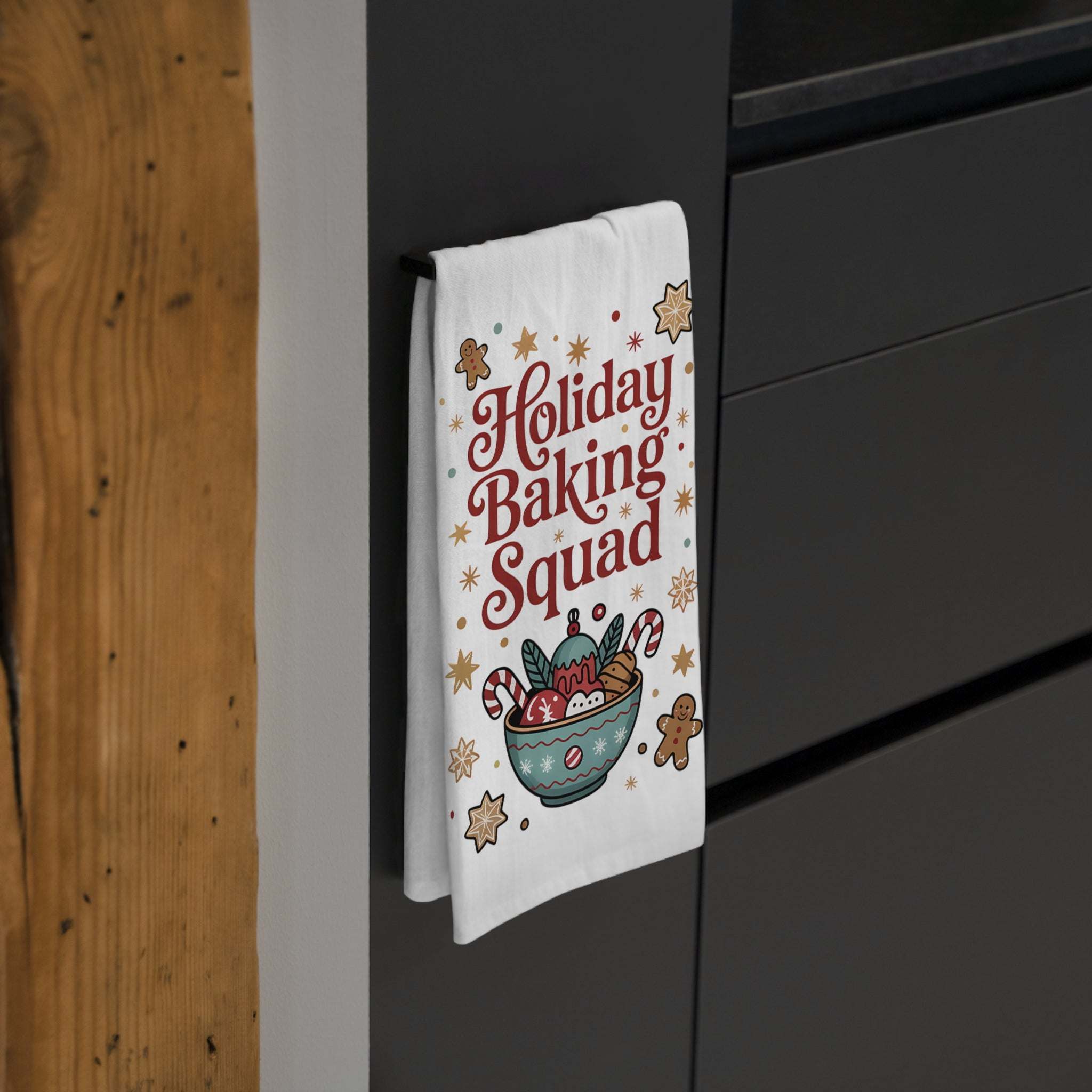 White cotton tea towel featuring 'Holiday Baking Squad' design, measuring 28\" × 28\" from Printify.